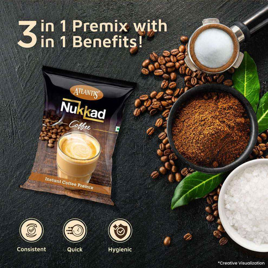 Packet of Atlantis Nukkad Coffee instant coffee premix with coffee beans, ground coffee, and milk frother on a dark surface