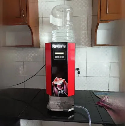 Nescafe 2 lane coffee machine price shown with water container on top in kitchen setting