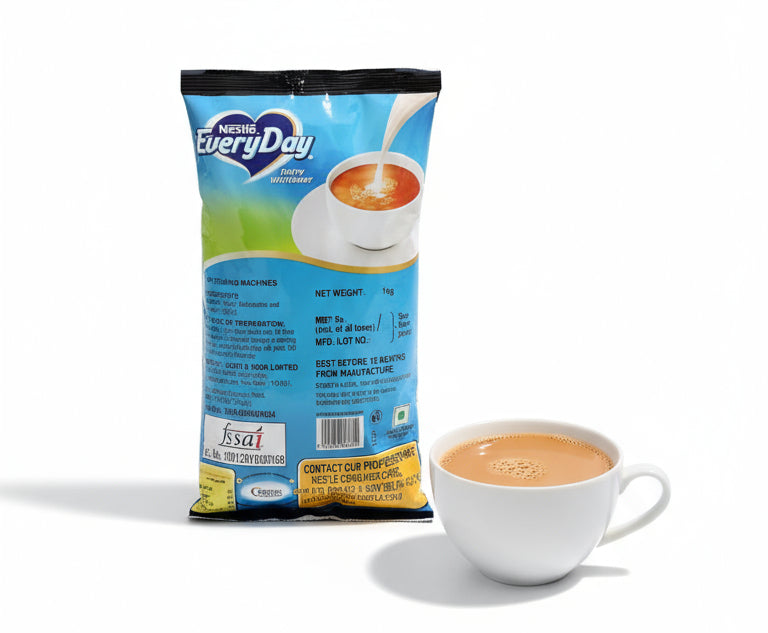Nestle Everyday dairy whitener 1kg pack next to a white cup filled with tea