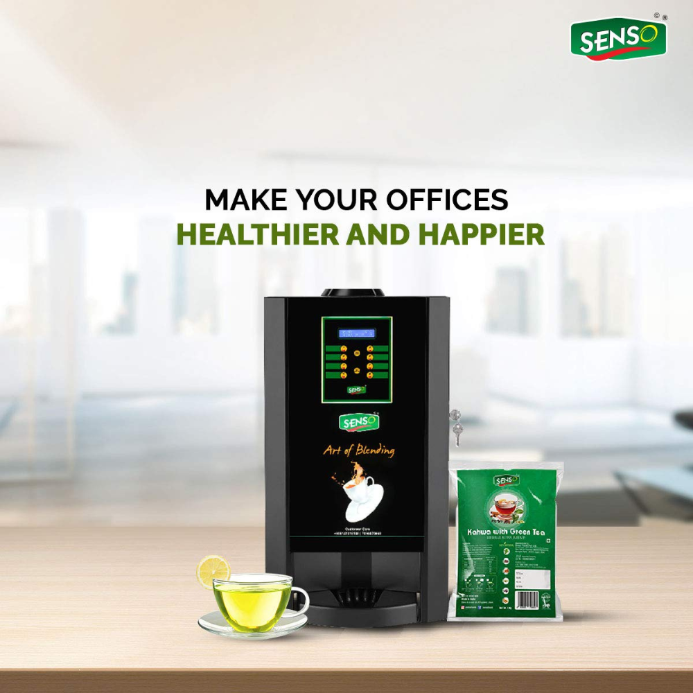 SENSO Instant Kahwa with Green pack beside a tea vending machine and a cup of green tea on a wooden table